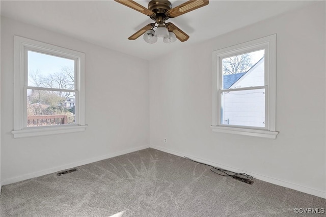 empty room with ceiling fan and carpet