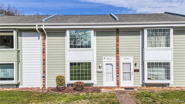 doorway to property with a yard