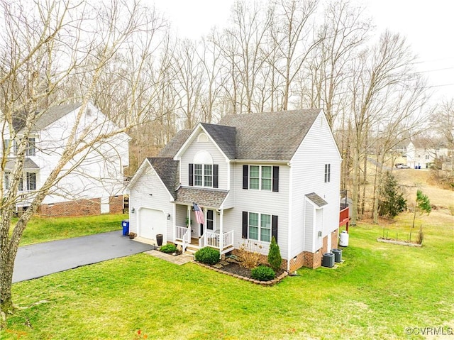 view of front of property featuring central AC unit, a garage, and a front lawn