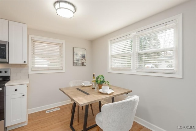 dining room with light hardwood / wood-style floors