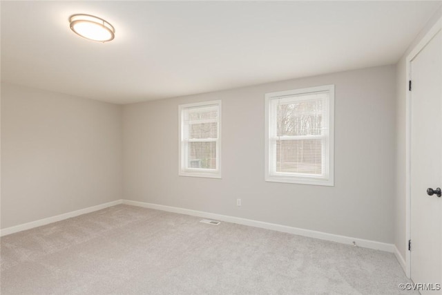 unfurnished room with light colored carpet