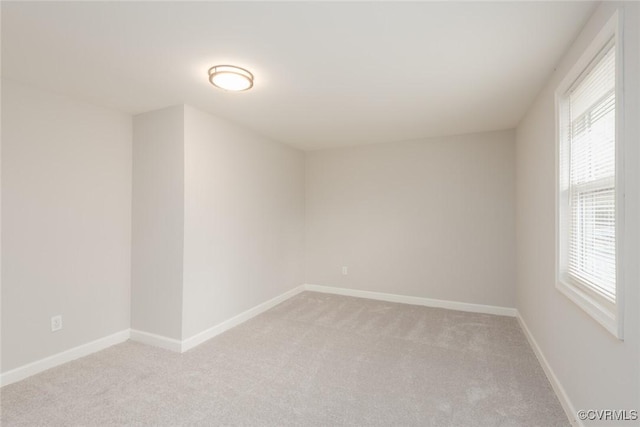 unfurnished room with light colored carpet