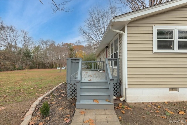 wooden terrace featuring a yard