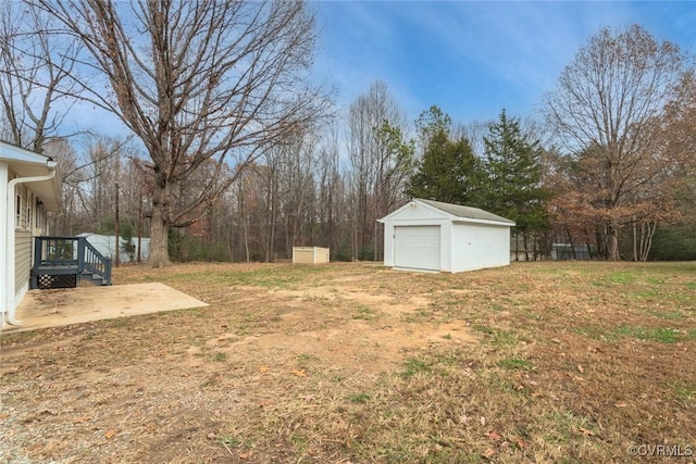 view of yard with a garage and a storage unit