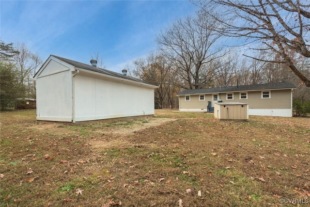 back of house with a lawn