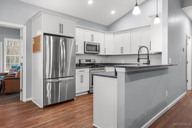 kitchen featuring white cabinetry, stainless steel appliances, and kitchen peninsula