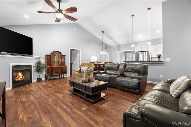 living room featuring high vaulted ceiling, hardwood / wood-style floors, and ceiling fan