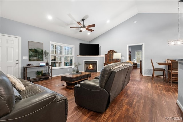 living room featuring dark hardwood / wood-style flooring, high vaulted ceiling, and ceiling fan