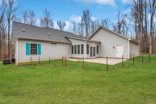 rear view of house with a yard, central AC unit, and a patio