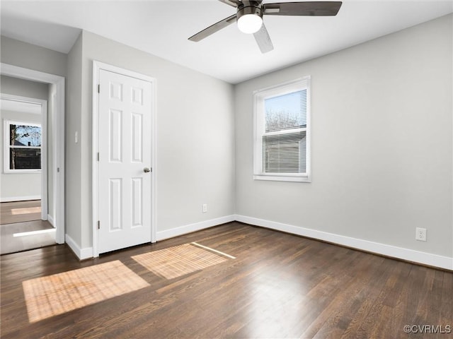 unfurnished room featuring ceiling fan and dark hardwood / wood-style flooring