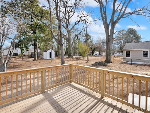 wooden terrace featuring a storage shed