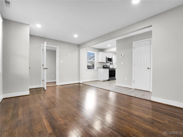 unfurnished living room featuring hardwood / wood-style flooring