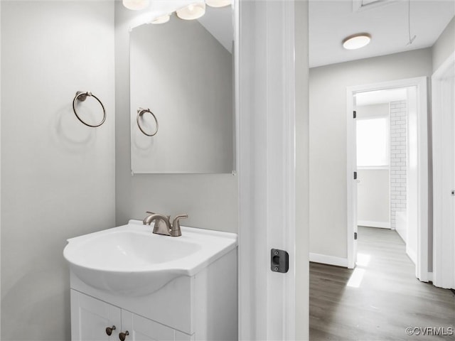 bathroom with hardwood / wood-style flooring and vanity