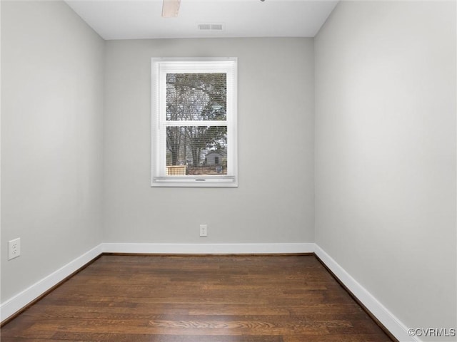 empty room featuring dark hardwood / wood-style flooring