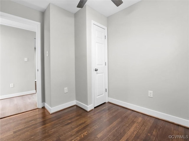 empty room featuring dark hardwood / wood-style floors and ceiling fan