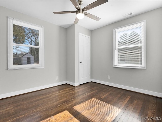 unfurnished room with dark hardwood / wood-style floors and ceiling fan