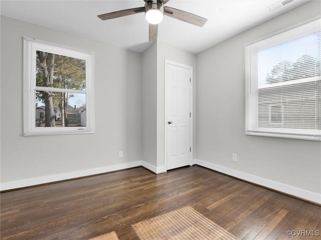 unfurnished bedroom with dark hardwood / wood-style floors and ceiling fan