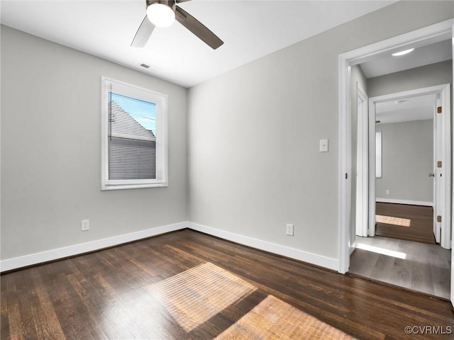 empty room featuring dark hardwood / wood-style floors and ceiling fan