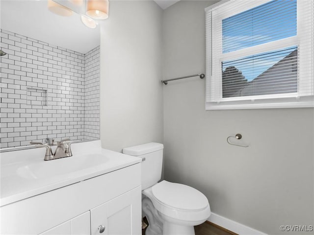 bathroom with vanity, ceiling fan, and toilet