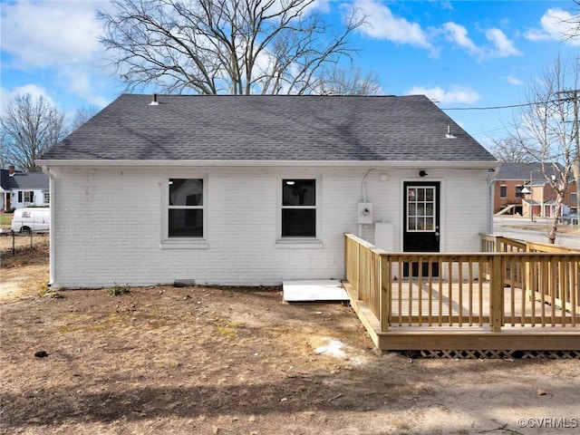 back of property featuring a wooden deck