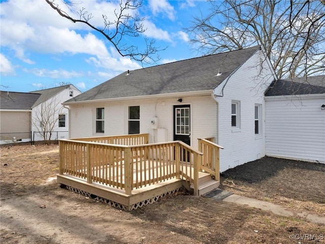 rear view of house featuring a deck