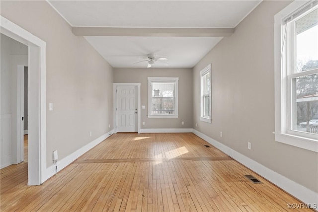 unfurnished room featuring light hardwood / wood-style flooring, beamed ceiling, and ceiling fan