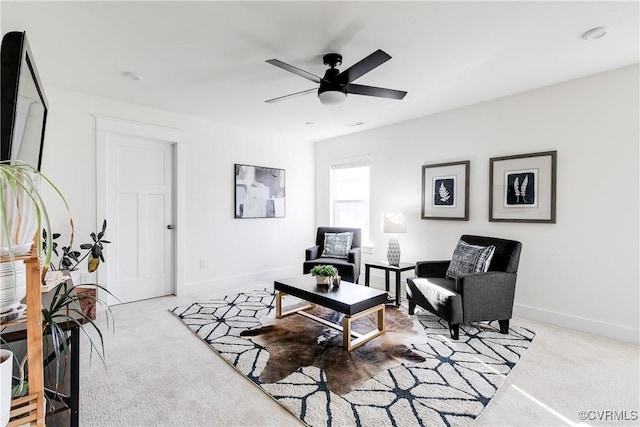 sitting room featuring light carpet and ceiling fan