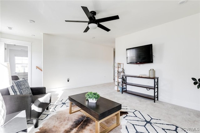 carpeted living room featuring ceiling fan