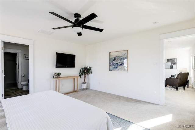 carpeted bedroom featuring ceiling fan and ensuite bathroom