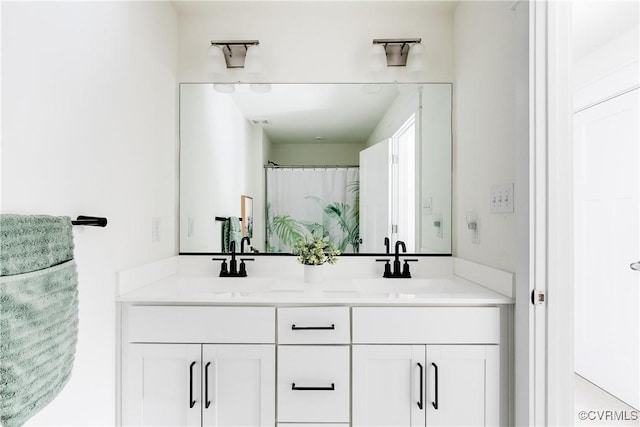 bathroom featuring walk in shower and vanity