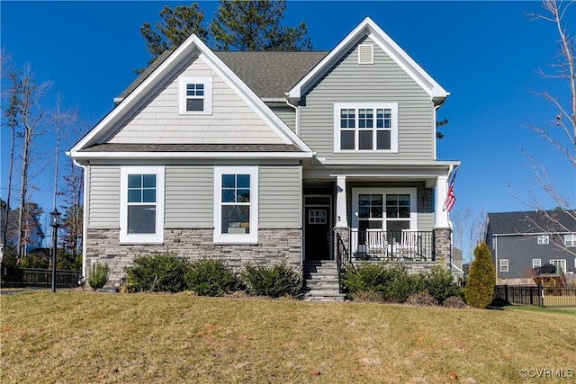 craftsman house with a front yard and covered porch