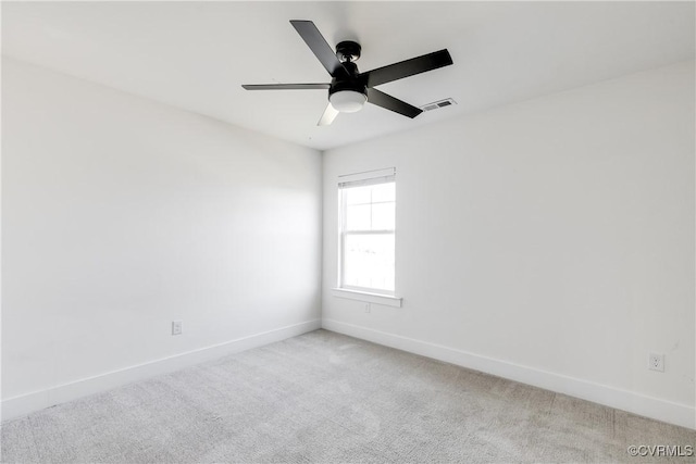 spare room featuring light carpet and ceiling fan