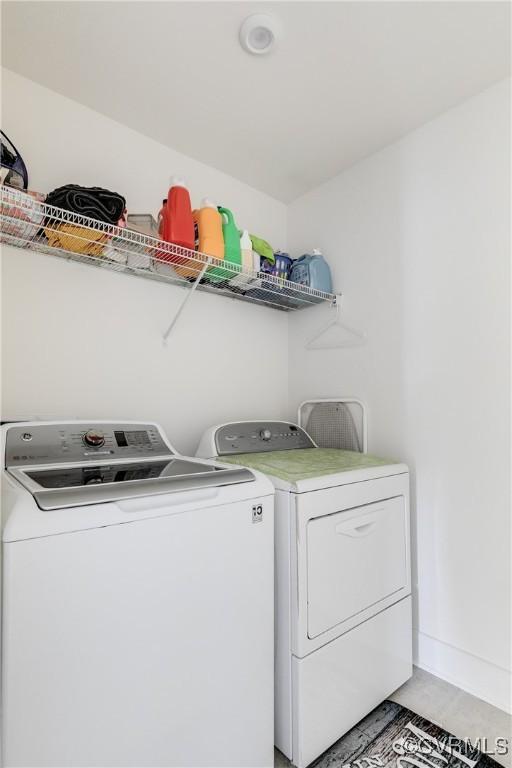 clothes washing area with separate washer and dryer