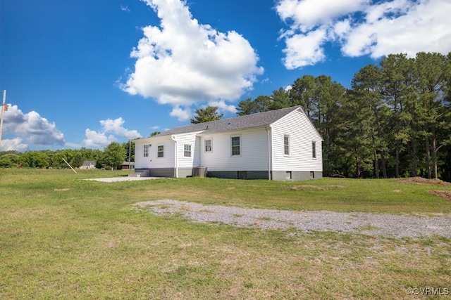 rear view of property featuring a yard