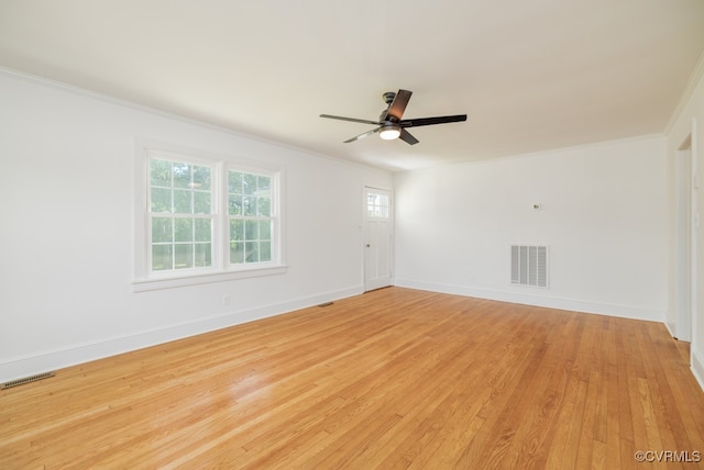 spare room with crown molding, ceiling fan, and light wood-type flooring