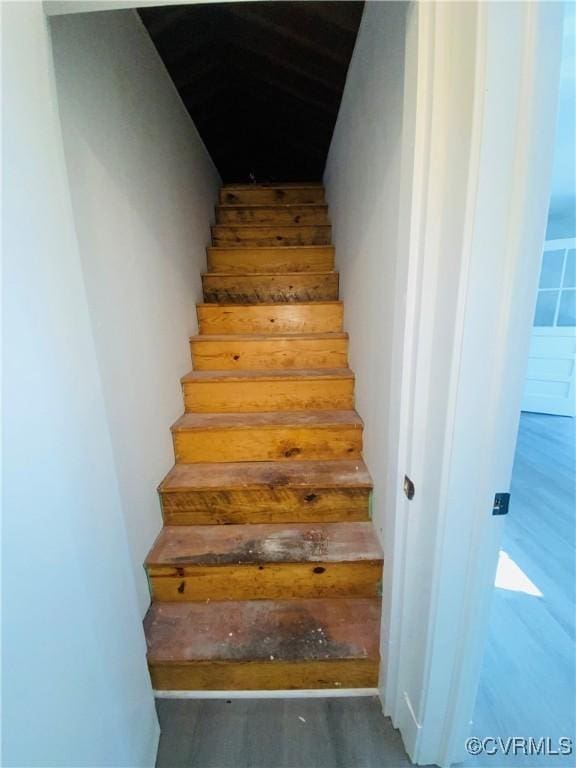 staircase featuring hardwood / wood-style flooring