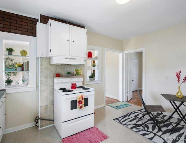 kitchen with electric range, baseboards, white cabinets, light countertops, and under cabinet range hood