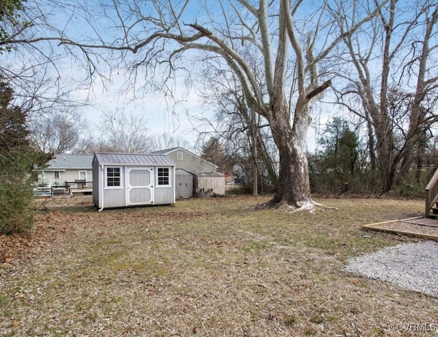 view of yard with an outbuilding and a shed