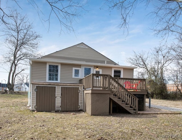 rear view of house with stairs and a deck