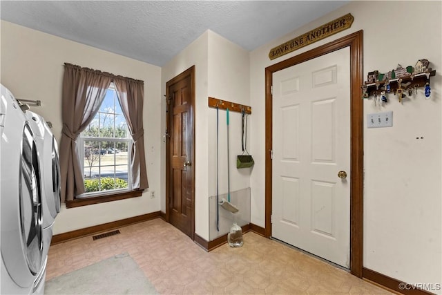 laundry room with a textured ceiling, laundry area, visible vents, independent washer and dryer, and light floors