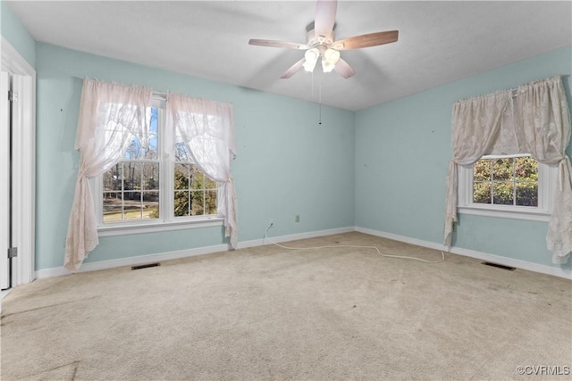 empty room with light carpet, visible vents, and baseboards