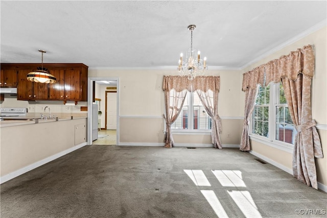 unfurnished dining area featuring crown molding, light carpet, a sink, and baseboards