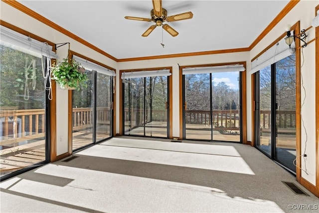 unfurnished sunroom featuring visible vents and a ceiling fan