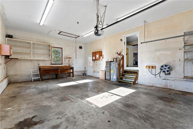 garage with a garage door opener and water heater