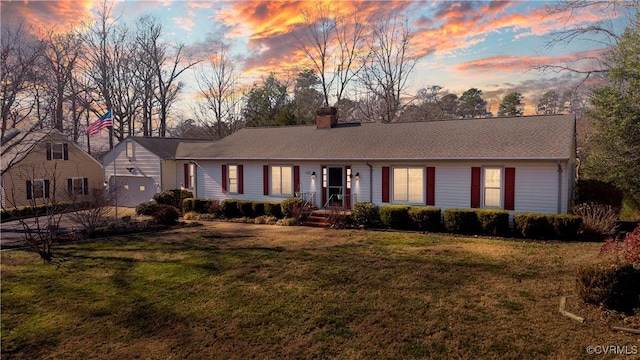 single story home with a lawn and a chimney