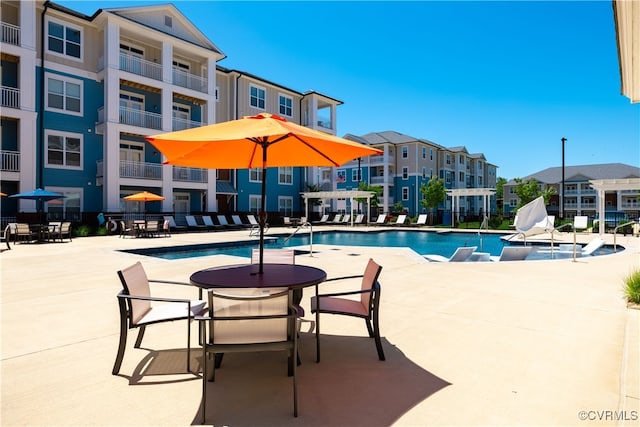 view of swimming pool with a pergola and a patio