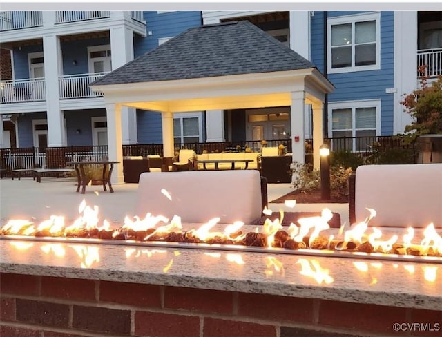 exterior space featuring a gazebo, a patio area, and a fire pit