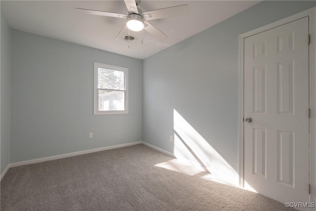 carpeted spare room featuring ceiling fan