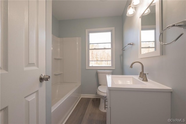 full bathroom with wood-type flooring, plenty of natural light, vanity, and toilet