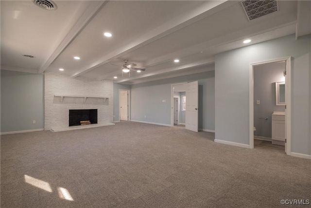 unfurnished living room featuring a brick fireplace, beam ceiling, ceiling fan, and carpet flooring